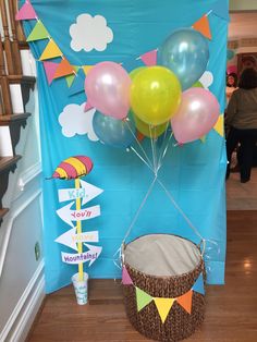 a basket with some balloons in it on the floor