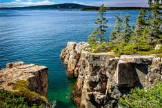 the water is crystal blue and clear as it sits at the edge of some cliffs