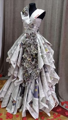 a dress made out of newspapers sitting on top of a table