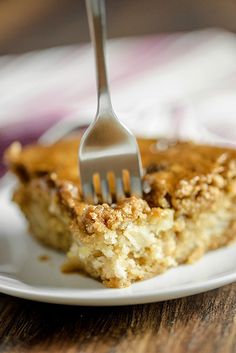 a fork stuck into a piece of cake on a plate