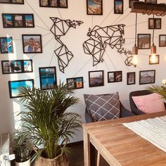 a living room filled with furniture and lots of pictures on the wall above it's coffee table