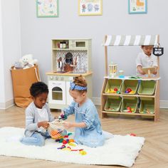 two children playing with toys in a playroom