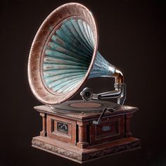 an old fashioned record player with a blue and gold horn on it's stand