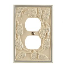 a light switch cover with leaves on it