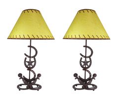 a pair of table lamps with a yellow shade on each lamp and an iron base