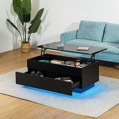 a living room with a couch, coffee table and blue sofa in it's center