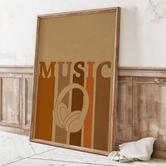 an old poster with headphones on it next to a wooden cabinet and white cloth