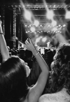 people at a concert with their hands in the air