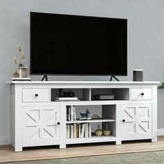 a flat screen tv sitting on top of a white entertainment center