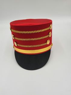 The Nicky Bigs Novelties™ ADULT TOY SOLDIER HAT Become the Toy Soldier, or the Band Leader in the Parade! Select from a Blue, Black, or Red hat featuring gold accents. Each hat is comfortable and lightweight. Great for Halloween, Cosplay, Theater and more! Perfect accessory for Nutcracker, Conductor, Toy Soldier, Band Leader and more! Hat stands approximately 5" tall and fits approximately 58 cm, 7-1/4 American 7-3/8 European. ⭐ Adult Toy Soldier Hat. Select from Blue/Red, Red/Black, and Black. ⭐Each hat features gold trim strips and button accent.  Perfect for Men, Women, and Teens! ⭐Lightweight and comfortable to wear! Each cosplay hat stands approximately 5" tall. ⭐Sized approximately 58 cm or 22.8 inches in circumference.  ⭐Each hat is made of Polyester fabric with a Cardboard frame fo Adjustable Red Hat For Costume Party, Red Adjustable Hat For Costume Party, Novelty Red Costume Hats For Parties, Novelty Red Costume Hats And Headpieces For Parties, Novelty Red Costume Hats And Headpieces For Costume Party, Red Novelty Costume Hats For Costume Party, Red Themed Costume Accessories For Gifts, Red Themed Costume Accessories For Gift, Themed Red Costume Accessories For Gift