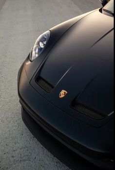 the front end of a black sports car