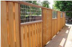 a wooden fence that is next to a building