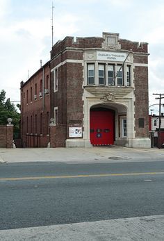 an old brick building with a red door