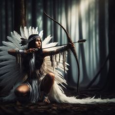 a woman dressed in native american clothing holding a bow and arrow while sitting on the ground