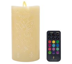 a lit candle next to a remote control on a white background with the image of a butterfly