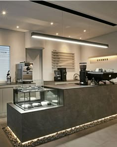 a kitchen with an oven, counter and lights on the ceiling is shown in this image