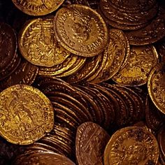 a pile of gold coins sitting next to each other