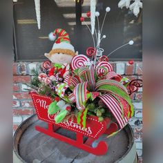 a red sleigh filled with candy canes and christmas decorations