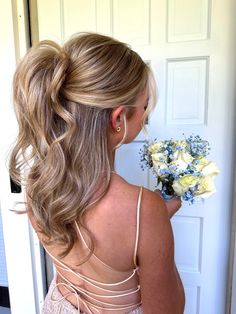 a half up half down prom hair inspiration. This style is super easy- after your hair is in curls use an elastic to create a half up pony tail, hold the pony tail up towards the crown of your head and then secure a bobby pin in underneath. after this tease the pony tail hiding the elastic/bobby pin and give an illusion of a voluminous half up pony. Hoco Updos Ponytail, Low Ponytail Homecoming Hair, Pony Wedding Guest Hair, Cute Half Up Half Down Hoco Hair, Hair Inspiration For Wedding Guest, Hoco Hair Inspo Ponytail, Half Up Half Down Hair Braided Bun, Hoco Hair Ideas Half Up Half Down, Half Pony Bridesmaid Hair