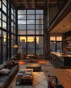 a living room filled with lots of furniture and windows next to a bar in front of a cityscape