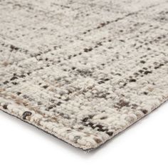 an area rug that is made up of various colors and sizes, including grays