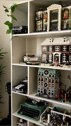 a book shelf filled with lots of toy buildings and toys on top of each other