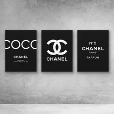 three black and white chanel posters hanging on the wall in a minimalistic room