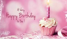 a pink cupcake with a lit candle on it's top and the words, a very happy birthday to you