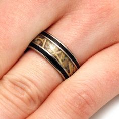 a close up of a person's hand with a wedding ring