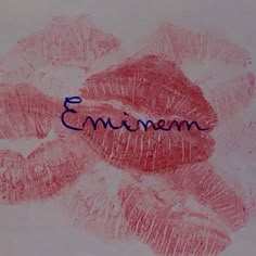 the word emiimen written in blue ink on a white paper with red lips