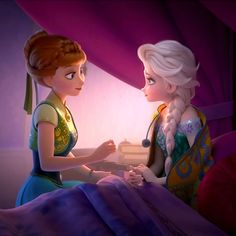 two princesses sitting on a bed looking at each other