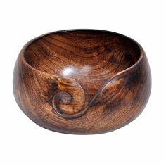 a wooden bowl with a spiral design on it