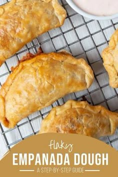 baked empanada dough on a cooling rack with dipping sauce in the background and text overlay