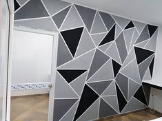 a room that has been painted with black and white geometric designs on the wall,