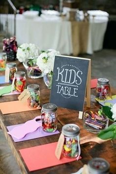 the table is set up with candy jars and place cards