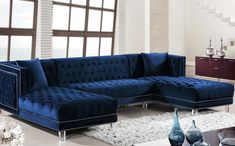 a living room with blue couches and white rugs