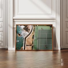 an aerial view of a tennis court and the ocean