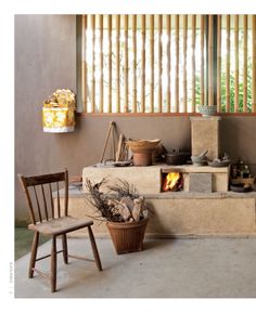 a living room with a fire place next to a wooden chair and other items on the floor