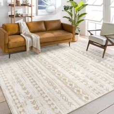 a living room with a couch, chair and rug