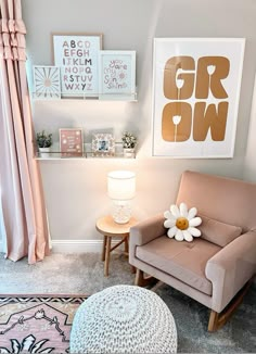 a chair and ottoman in a small room with pink curtains on the window sill