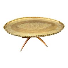 a golden tray with wooden legs on a white background