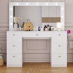 a white vanity with lights on it and a handbag