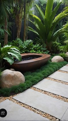 an outdoor bathtub surrounded by plants and rocks