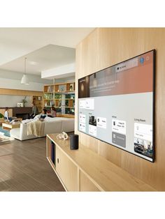 a living room filled with furniture and a flat screen tv mounted to the side of a wall