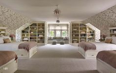 there are three beds in this room with built - in bookshelves