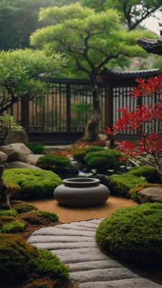 a garden with rocks, grass and trees