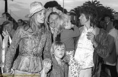 black and white photograph of group of people in costume at an outdoor event with one woman holding the other's hand