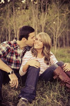 a bride and groom hugging each other in the park