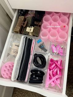 the drawer is filled with lots of crafting supplies