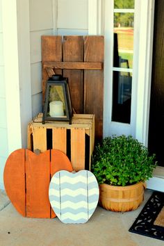 a front porch decorated with wooden signs and potted plants